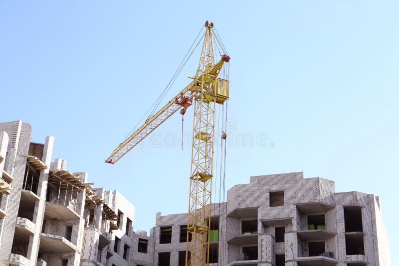 Construction Site with Tower Crane Near Unfinished Building Stock Photo