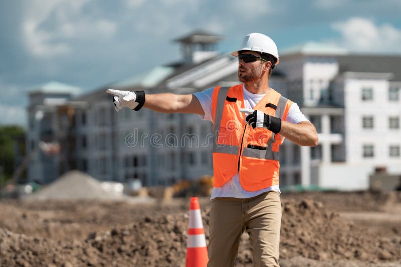 Construction Site Worker in Helmet Working Outdoor. a Builder in a