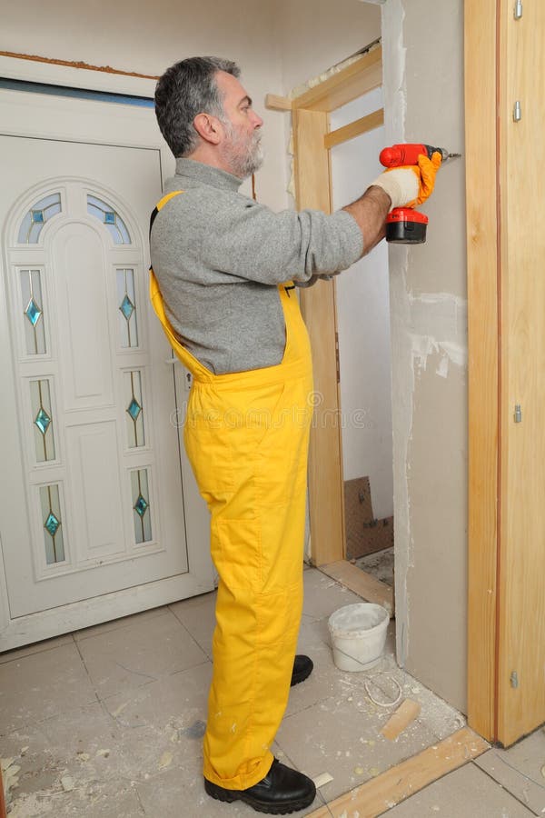 Man Installing Gypsum Plasterboard Construction of Housing Project with