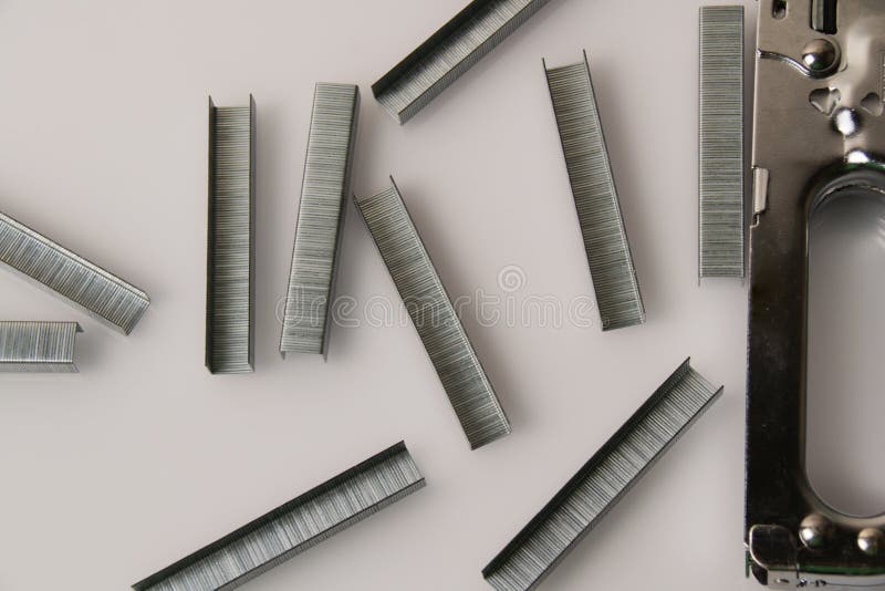 Construction Stapler and Staples on a Light Background with Copy Space. the Concept of