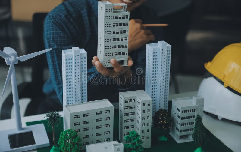 Construction and structure concept of Engineer or architect meeting for project working with partner and engineering tools on model building and blueprint in working site, contract for both companies