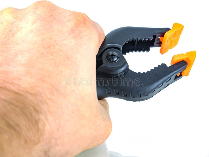 Construction tool black plastic clothespin on a white background royalty free stock photo