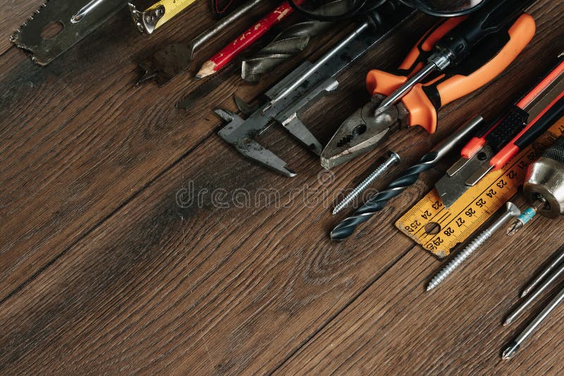 A construction tool on a brown wooden background. View from above. Picture background, screensaver. The concept of construction, royalty free stock images A construction tool on a brown wooden background. View from above. Picture background, screensaver. The concept of construction, royalty free stock images