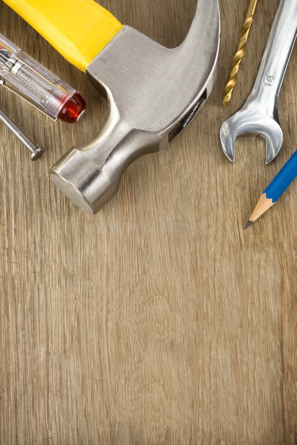 Construction tools on wood background