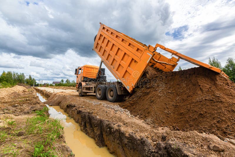 Construction Truck Tipping or Dumping Sand on Road during Construction