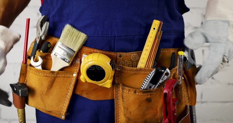 Construction worker arranges his tool belt