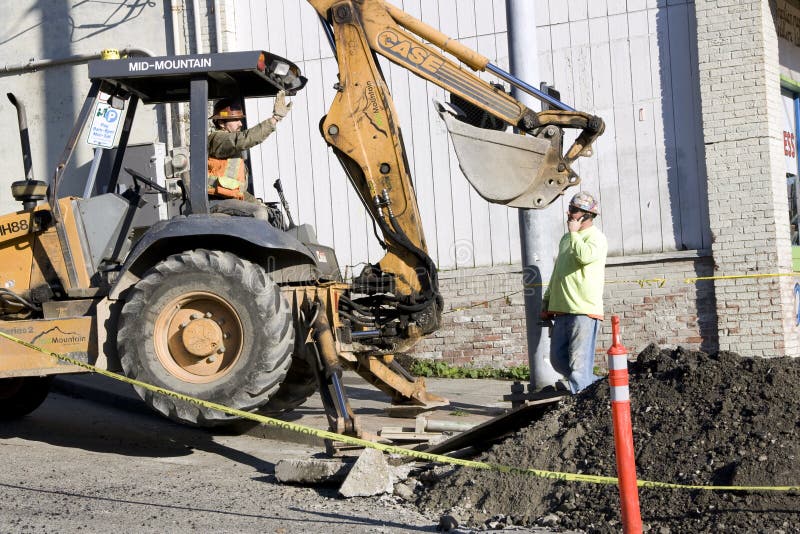 Construction worker bulldozer fixing street royalty free stock photo