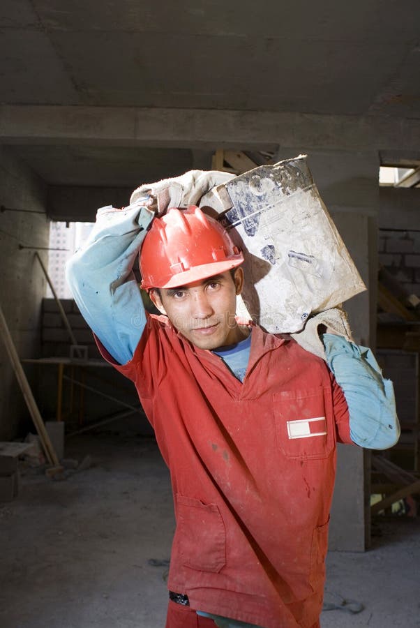 Construction Worker Carrying Material - Vertical