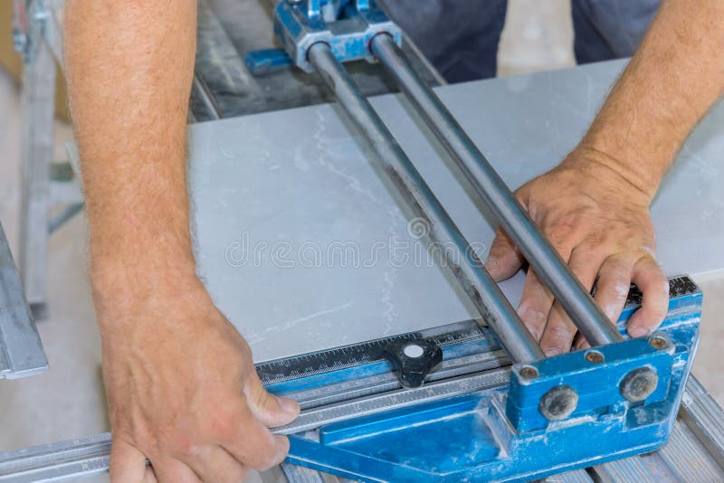 Construction Worker on Ceramic Tile Floor Cutting the Using Manual