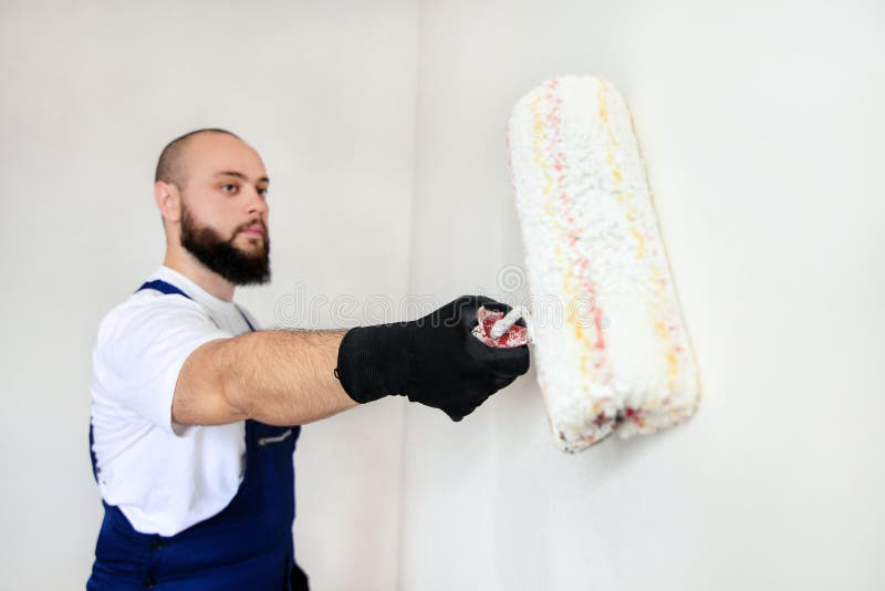 Construction Worker Doing Finish Renovation at Apartment. Painter Contractor Using White Paint