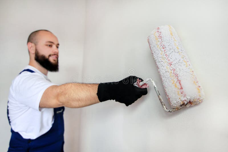 Construction Worker Doing Finish Renovation at Apartment. Painter Contractor Using White Paint