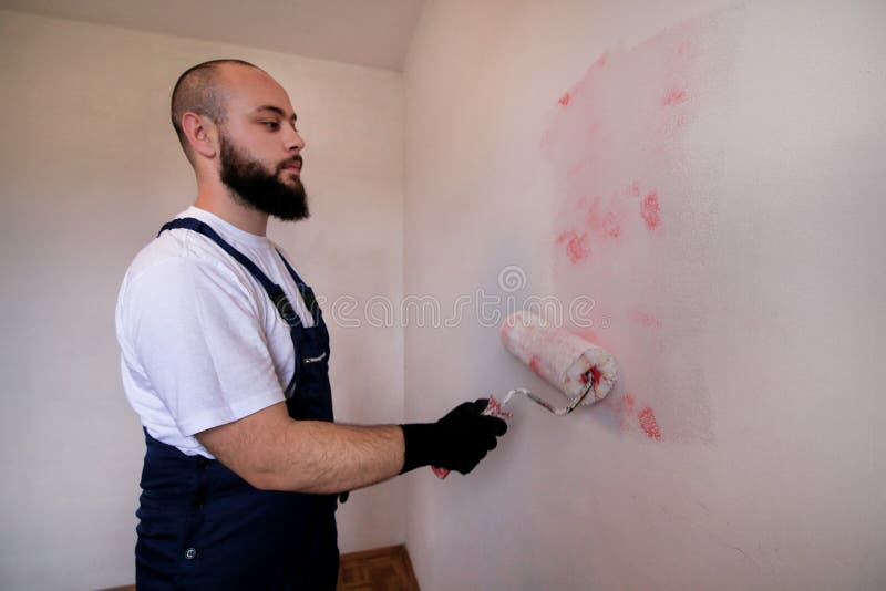 Construction Worker Doing Finish Renovation at Apartment. Painter Contractor Using White Paint