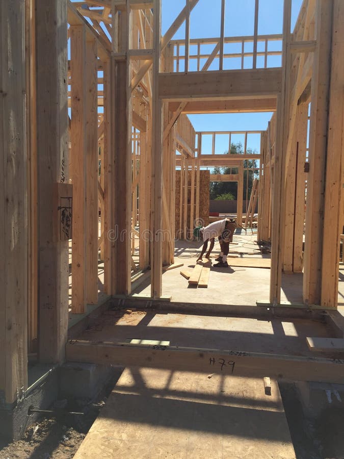 Construction worker doing the framing for the house. stock photo