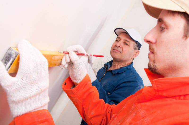 Construction worker doing measuring