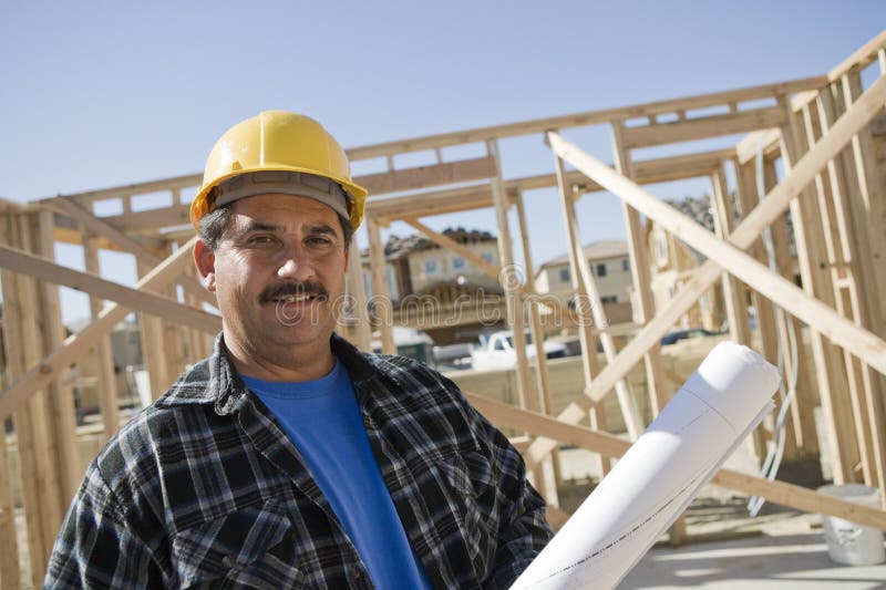 Construction Worker Holding Blueprint stock photo