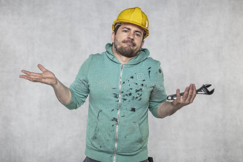 The construction worker holds the key in his hands, the key as a source of inspiration and ingenuity royalty free stock images