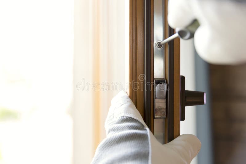 Construction worker installing window in house. Handyman fixing the window with screwdriver stock image