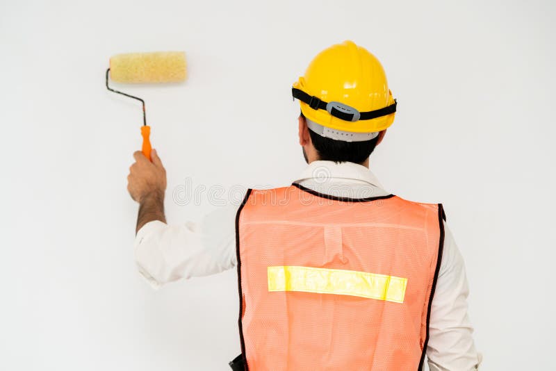 Construction worker painting the wall. stock images