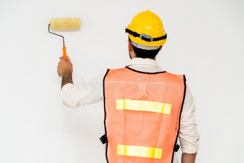 Construction worker painting the wall. stock photos
