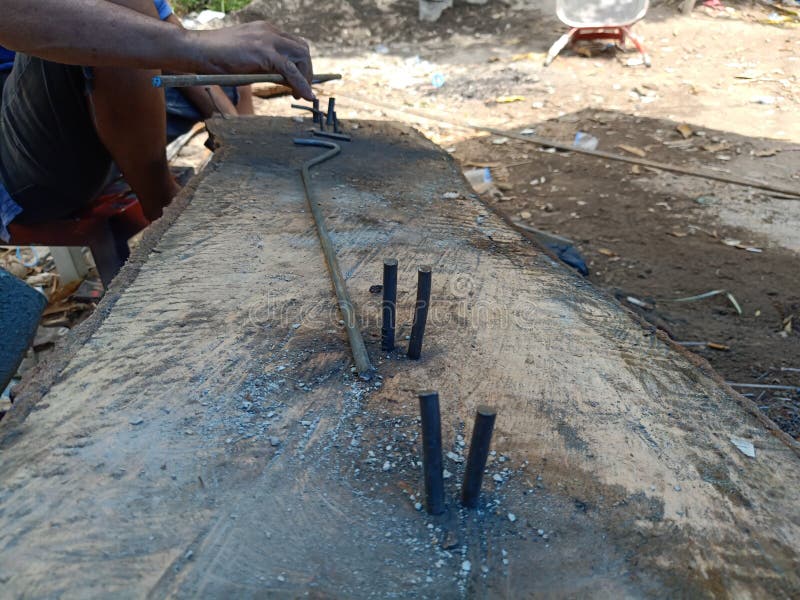 Construction Worker are Preparing Steel Poles for Building House Stock