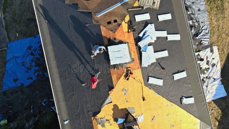 Construction worker on renovation roof the house installed new shingles