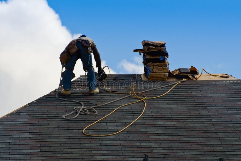 Construction worker on the roof stock photo Construction worker on the roof stock photo