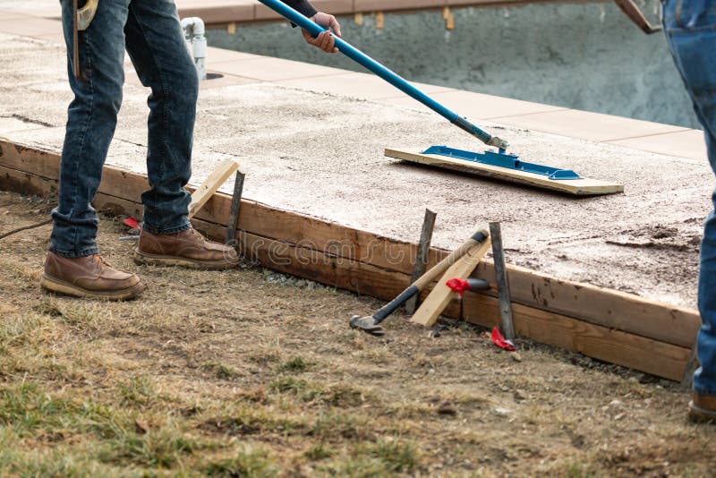 Construction Worker Smoothing Wet Cement with Trowel Tool Stock Image