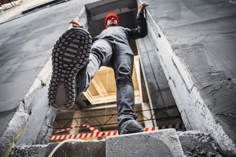 A construction worker steps into an unguarded, dangerous opening at a construction site. Violation of safety regulations