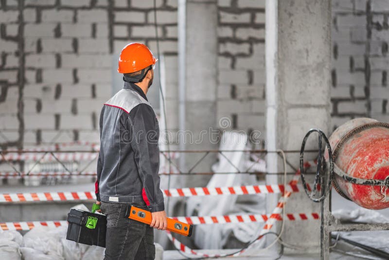 Construction Worker with a Suitcase with Tools and Level Tool, in
