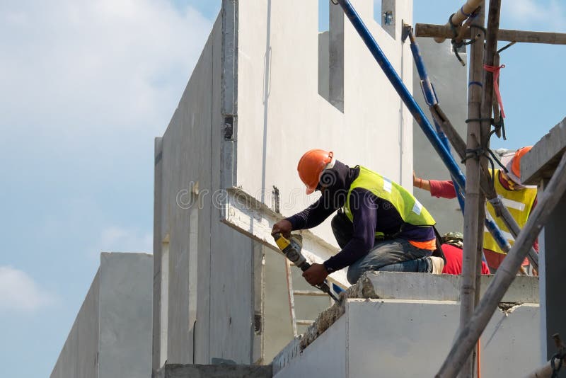 Construction Worker Use Electric Drill Drilling Concrete Wall in