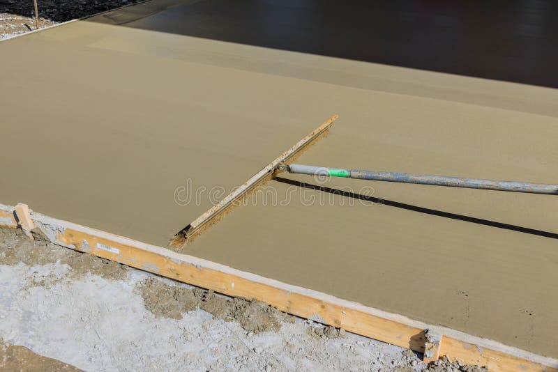 When a Construction Worker Uses a Broom To Brush Fresh Wet Concrete