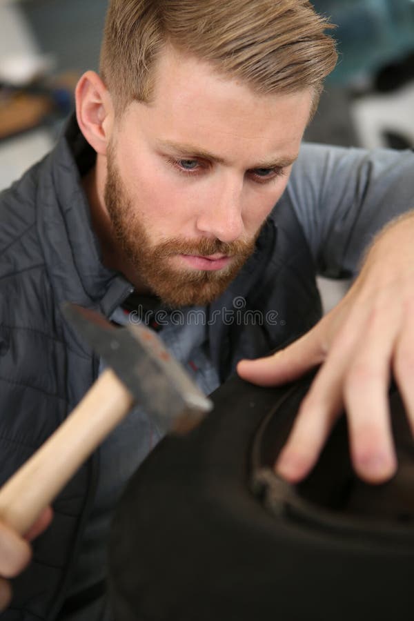 Construction Worker Using Hammer at Construction Site Stock Image