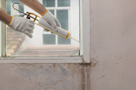 Construction Worker Using Silicone Sealant Caulk for Repair Leaked