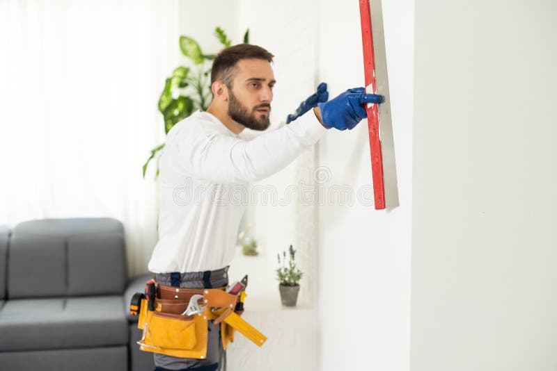 Construction Worker are Using Sponge and Plastering Trowel To Smooth