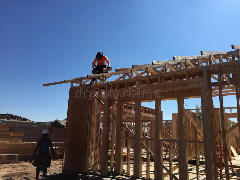 Construction worker working on the framing process for a new a house stock image