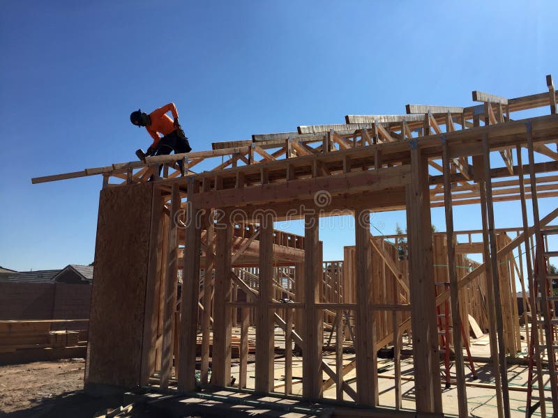 Construction worker working on the framing process for a new a house stock image