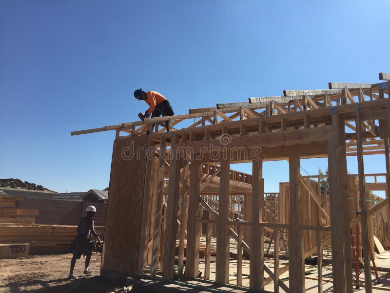 Construction worker working on the framing process for a new a house. stock image