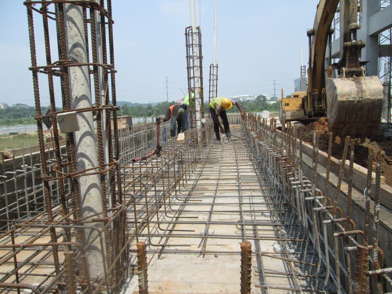 Construction workers fabricating steel reinforcement bar at the construction site.