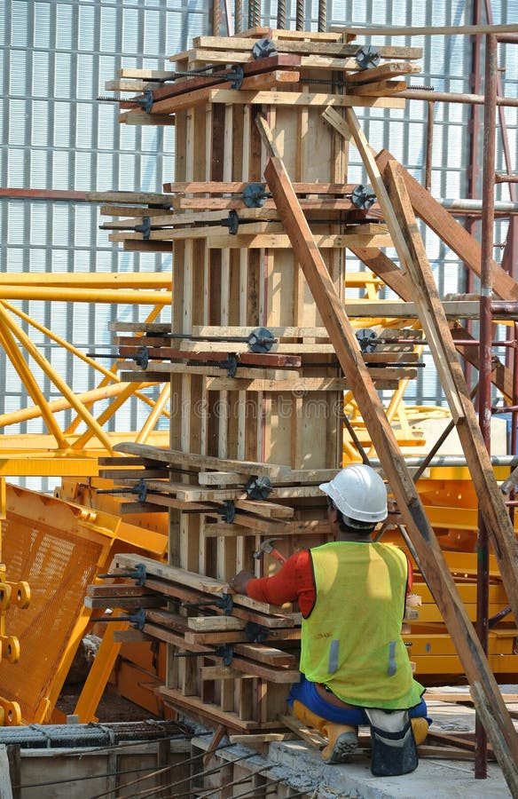 Construction Workers Fabricating Timber Column Formwork At The
