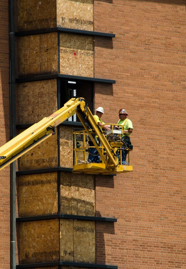 Construction Workers in a Hydraulic Lift Editorial Image Image of