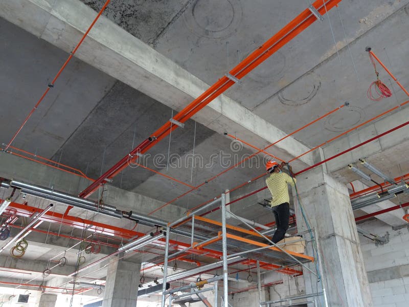 Construction Workers Installing Electrical Cable Tray and Doing Wiring