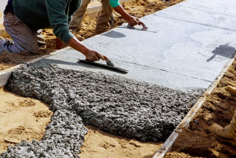 Construction Workers Laying Concrete Mixer With Concrete Mixer On