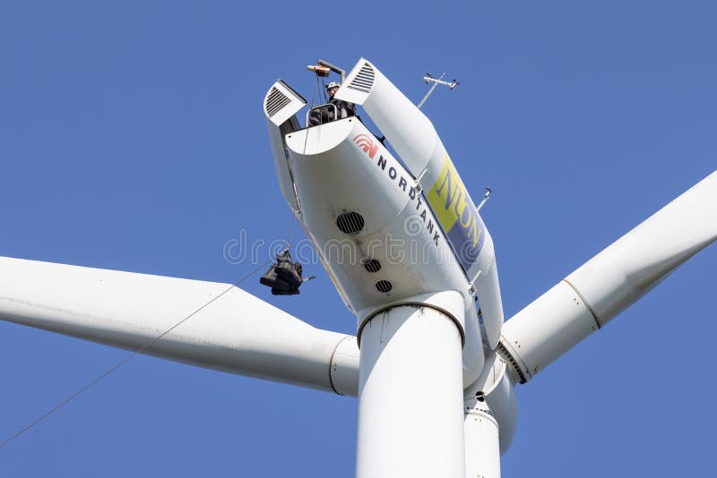 Construction Workers Lifting Set of Tools for Maintenance Wind Turbine