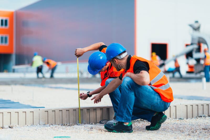 Construction Workers Measuring Stock Photo Image of construction