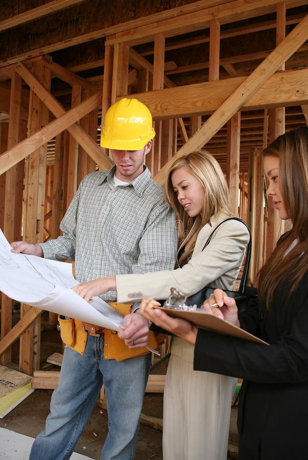 Two real estate agents working with a contruction home builder. Two real estate agents working with a contruction home builder