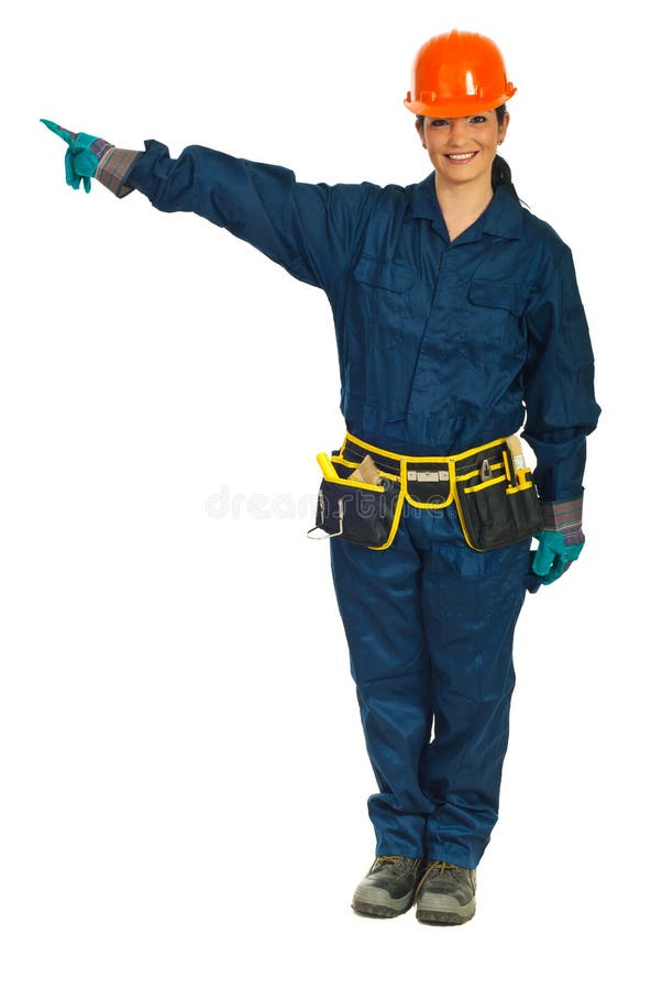 Full length of smiling constructor worker woman pointing in left part of image to copy space against white background. Full length of smiling constructor worker woman pointing in left part of image to copy space against white background