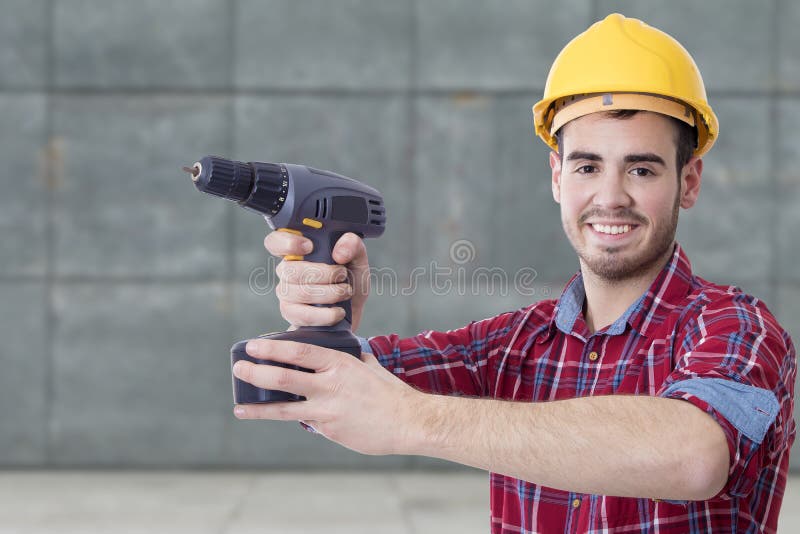 Construtor com a broca imagem de stock