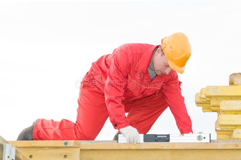 Builder worker checking horizontal with digital level tool at construction site. Builder worker checking horizontal with digital level tool at construction site