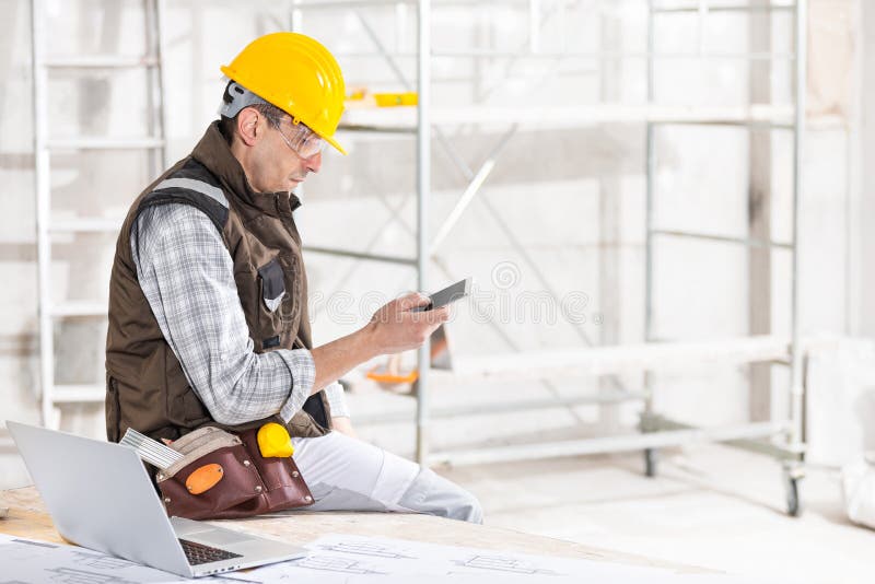 Construtor ou contratante que usa um telefone celular no local
