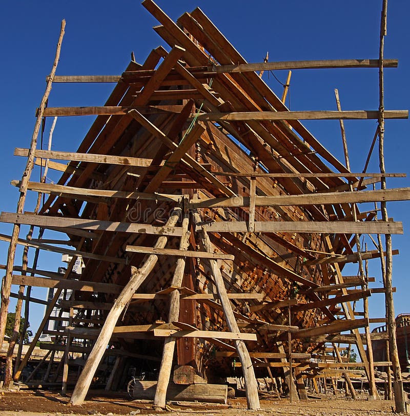 Shipbuilding in Gujarat, India. Mandvi is located on the seaside with an amazing wooden shipbuilding yard, where boats are built by hand. Shipbuilding in Gujarat, India. Mandvi is located on the seaside with an amazing wooden shipbuilding yard, where boats are built by hand.